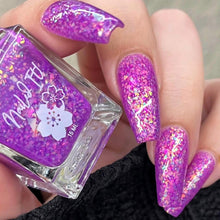 Purple glittery nails with a matching nail polish bottle.